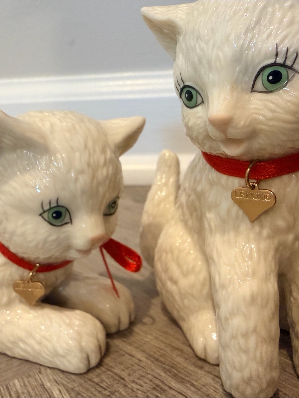 Lenox kittens crafted of ivory porcelain with red ribbon collars and gold charms